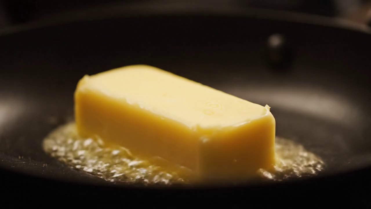 Visual: Close-ups of sizzling butter, caramelized ... - Veo 3 AI video prompt thumbnail