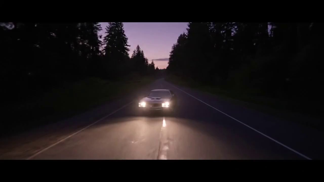 Aerial Shot (AS) - Car on Dirt Road into Forest