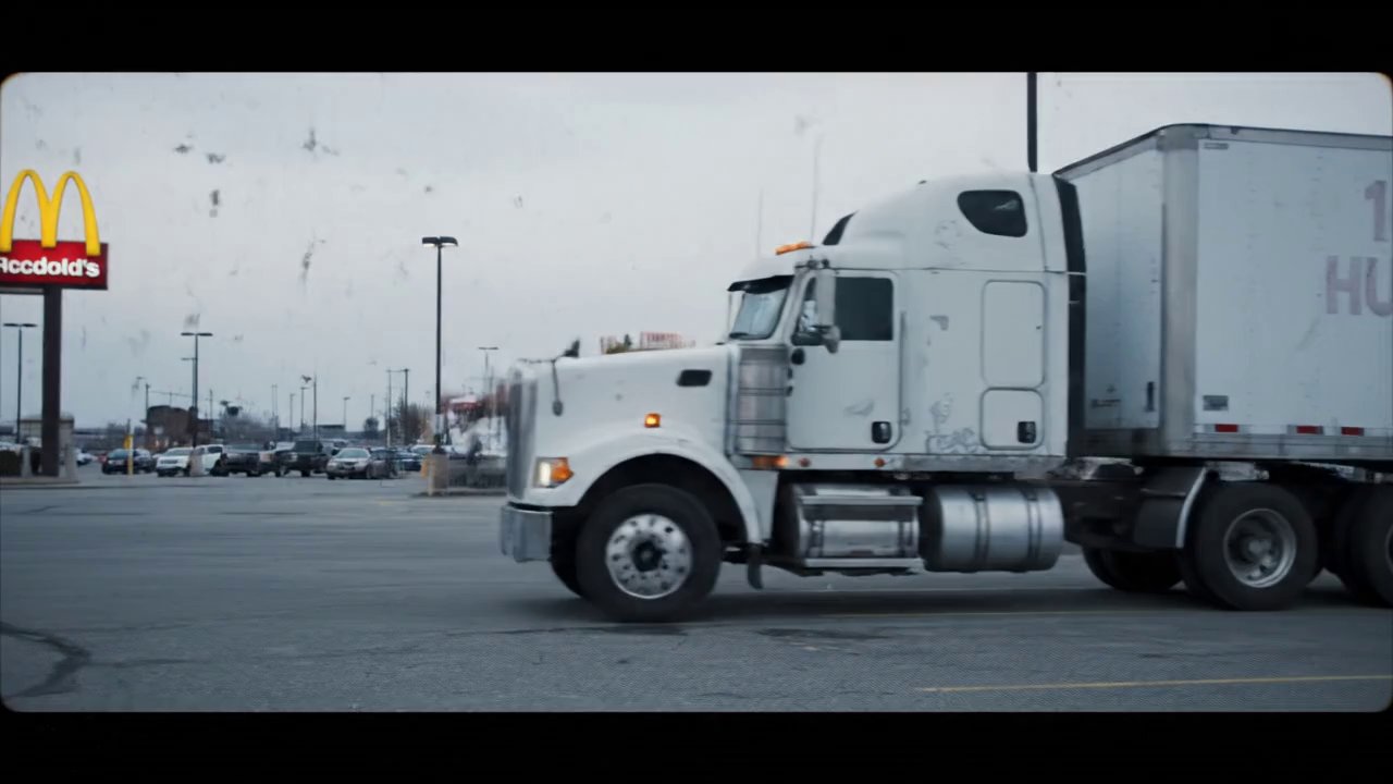 A large, weathered white semi-truck with a long tr... - Veo 3 AI video prompt thumbnail