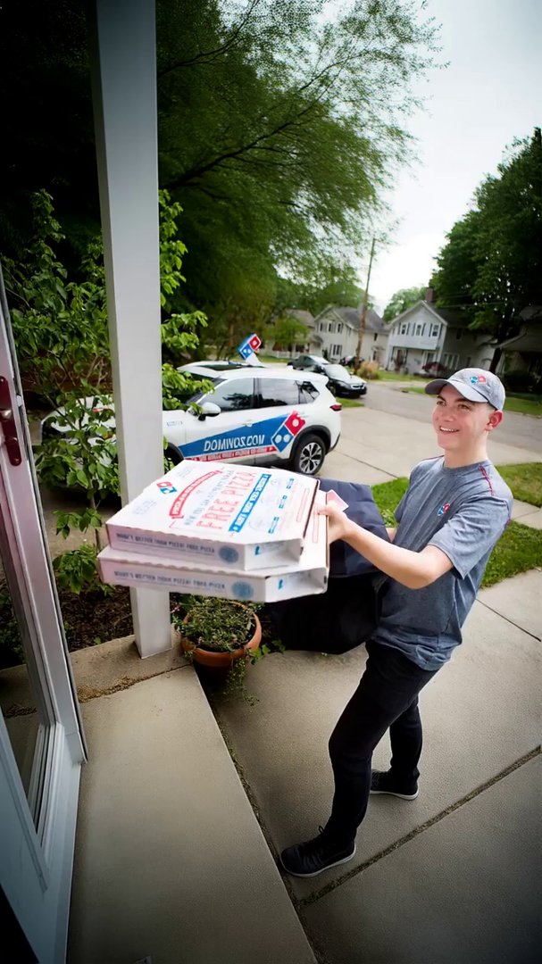 driver smiles and hands customer the pizza, saying... - Veo 3 AI video prompt thumbnail